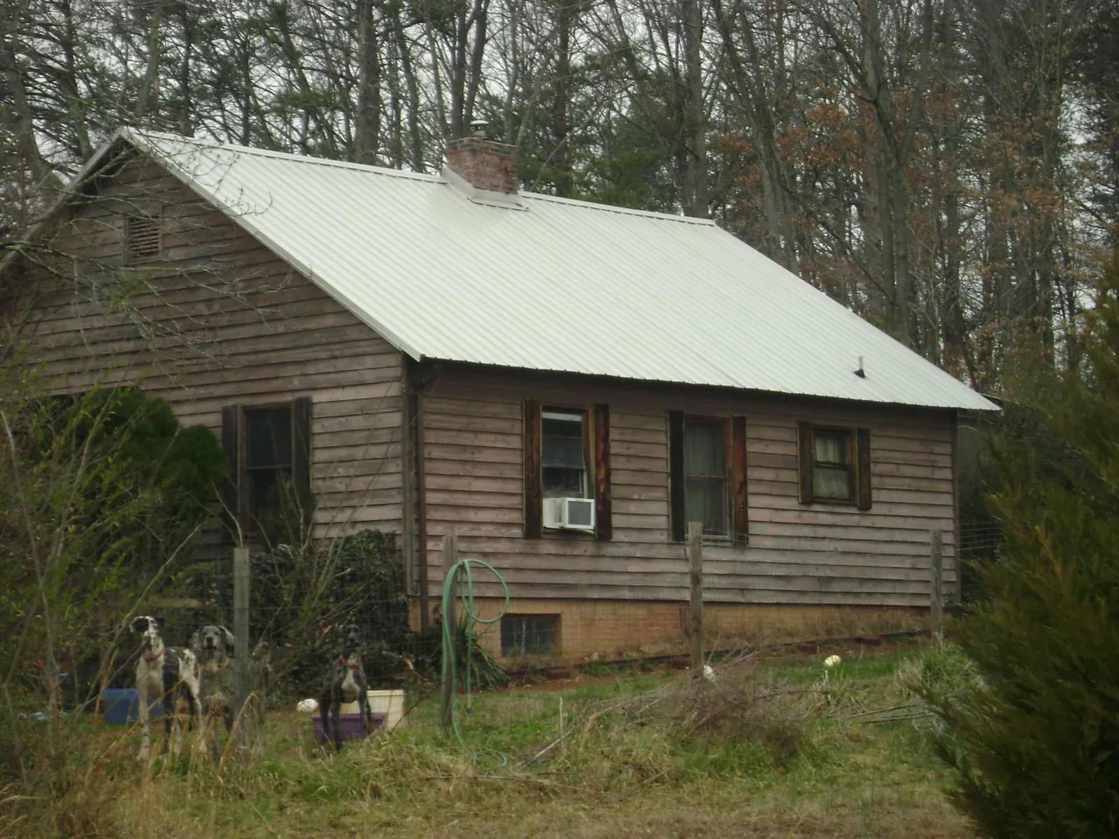 White metal roof on an old wood sided farmhouse, from a Metal Roof Installation job in Dowling